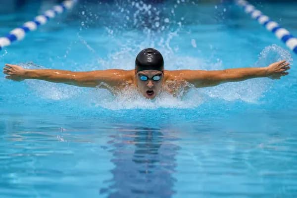 Athlete performing butterfly stroke in a swimming pool
